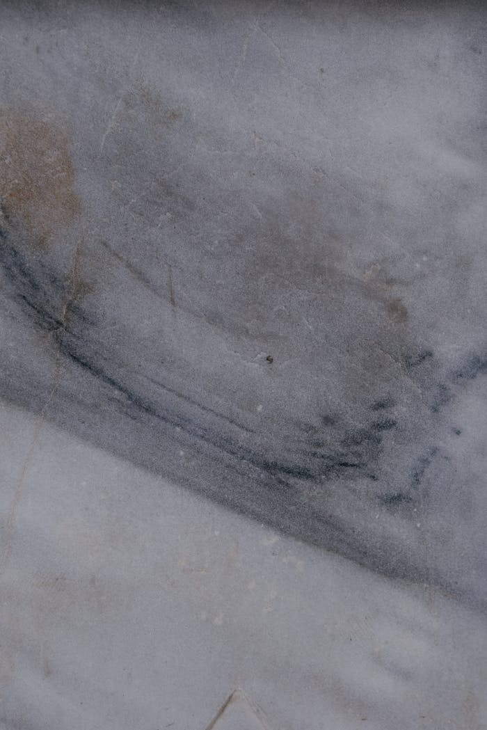Close-up of a textured grey marble surface, perfect for backgrounds.